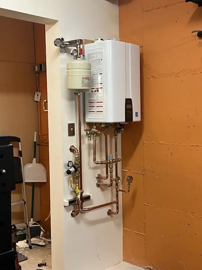 Plumbing technician inspecting water heater connections in Palm Springs